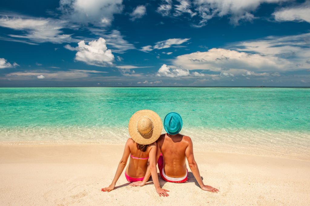Cayman Fertility Centre is the best IVF abroad due to high success rates and low cost IVF. Picture features a couple on a beautiful beach in Grand Cayman