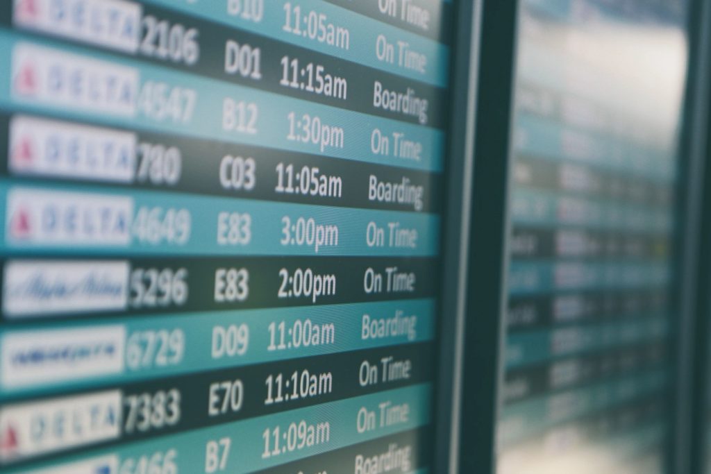 Flight travel board showing flight times. 